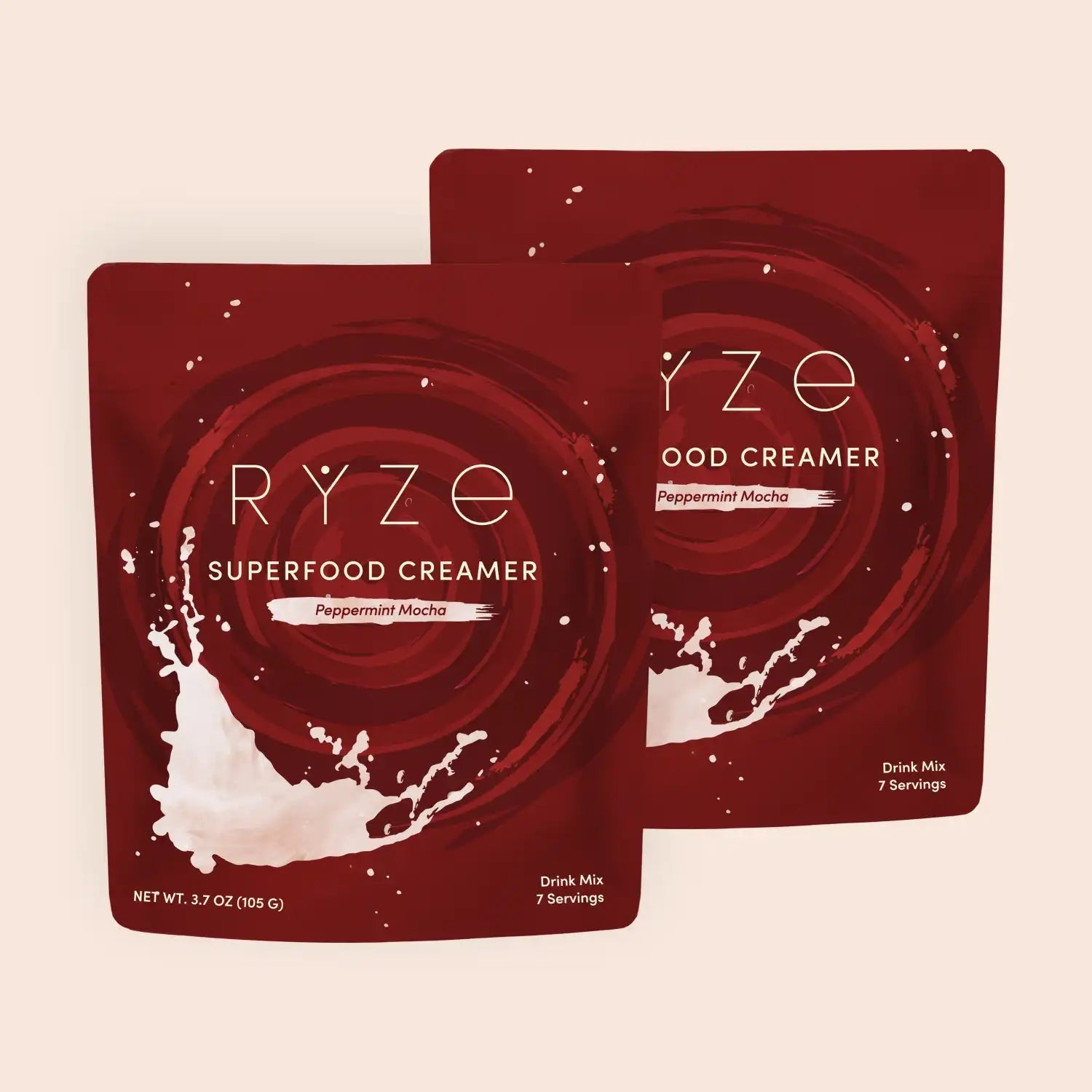 RYZE peppermint mocha superfood creamer packets with milk splash on deep red background